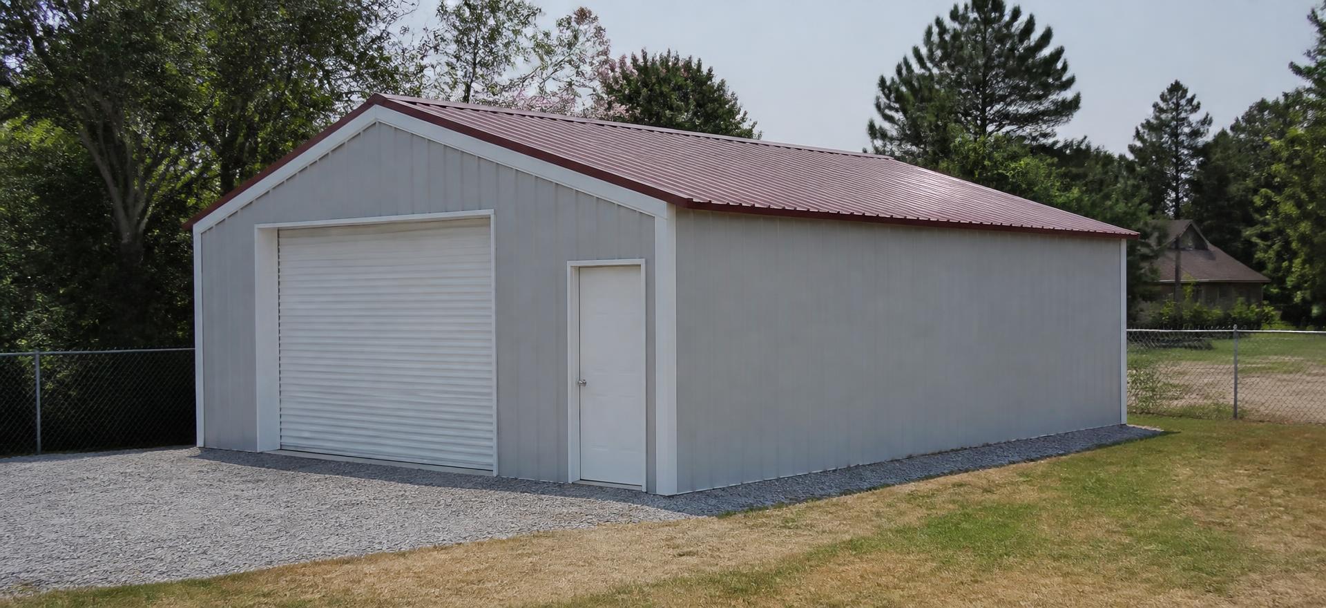 Concept photograph of a 24 by 36 foot light grey enclosed tube-frame metal garage with a red vertical-rib roof, one roll-up door and one walk door on a gravel pad; illustrative configuration, not a real project.