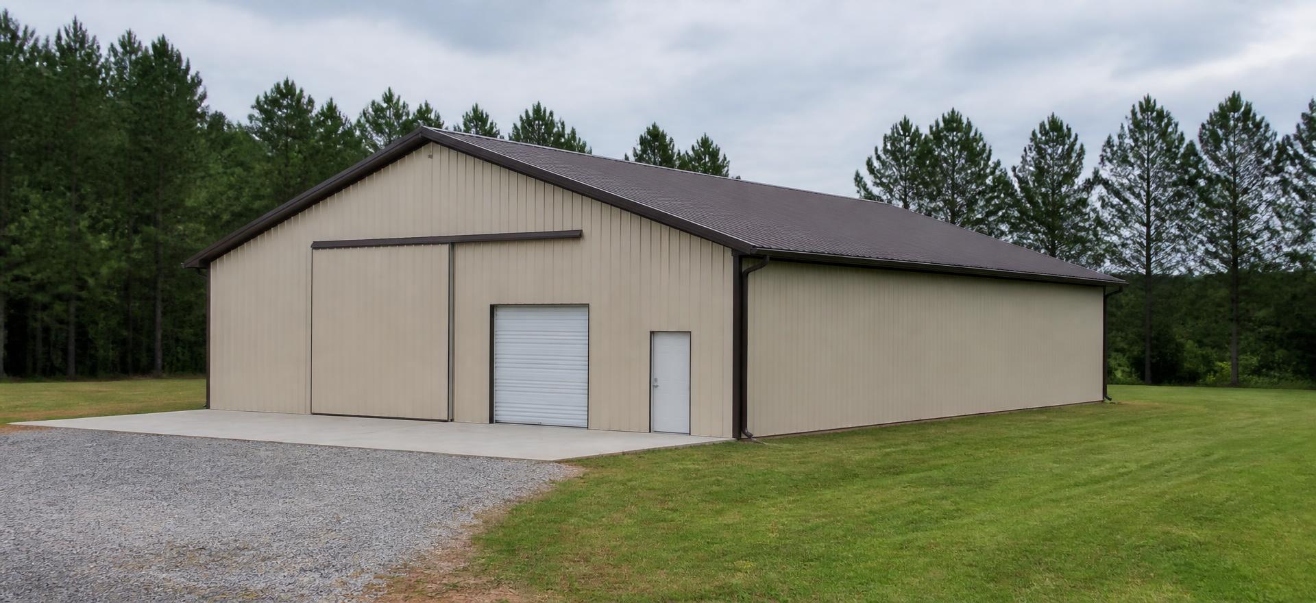 Concept photograph of a 40 by 80 foot tan post-frame shop building with a brown gable metal roof, sliding door, roll-up door and walk door on a concrete apron; illustrative configuration, not a real project.